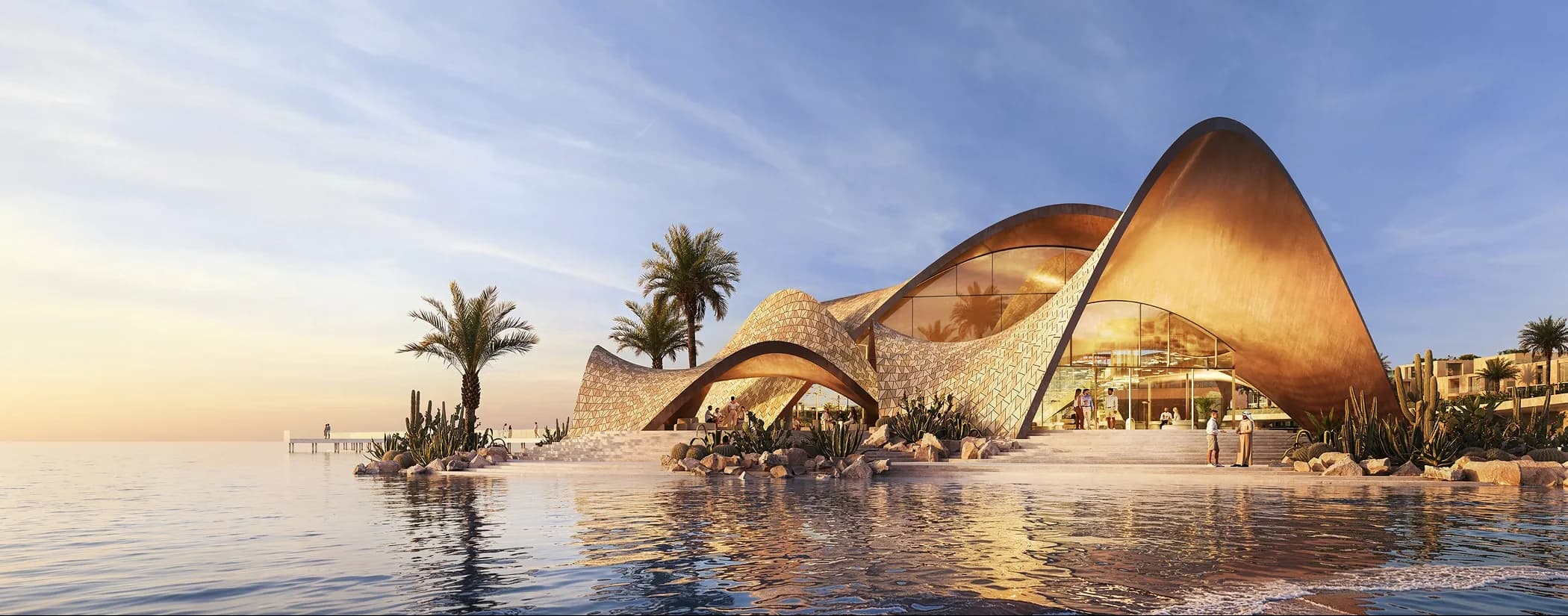 The curved Mira Coral Bay beach club on the water at dusk